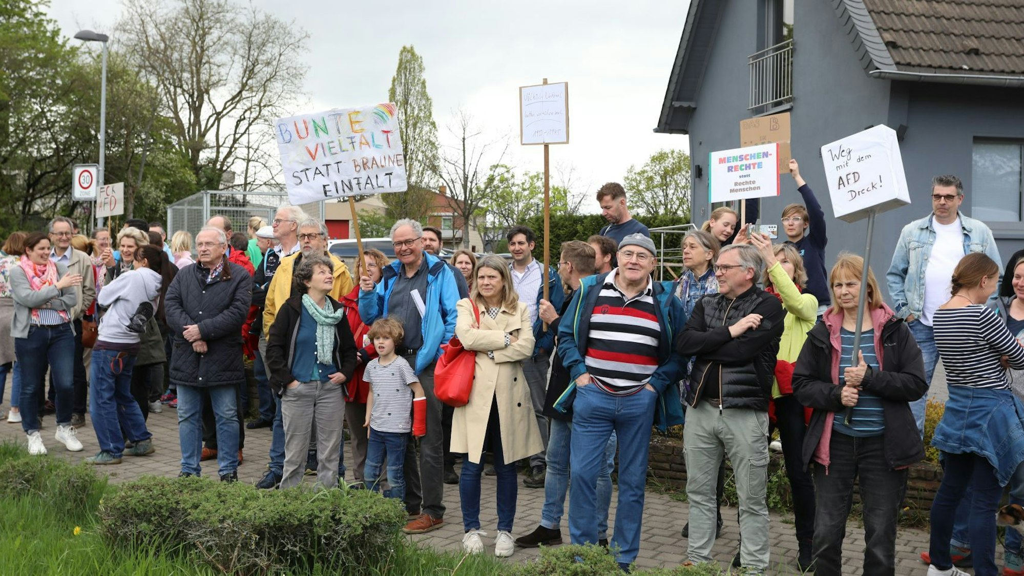Menschen, die gegen die AfD demonstrieren, halten Plakate in die Höhe.