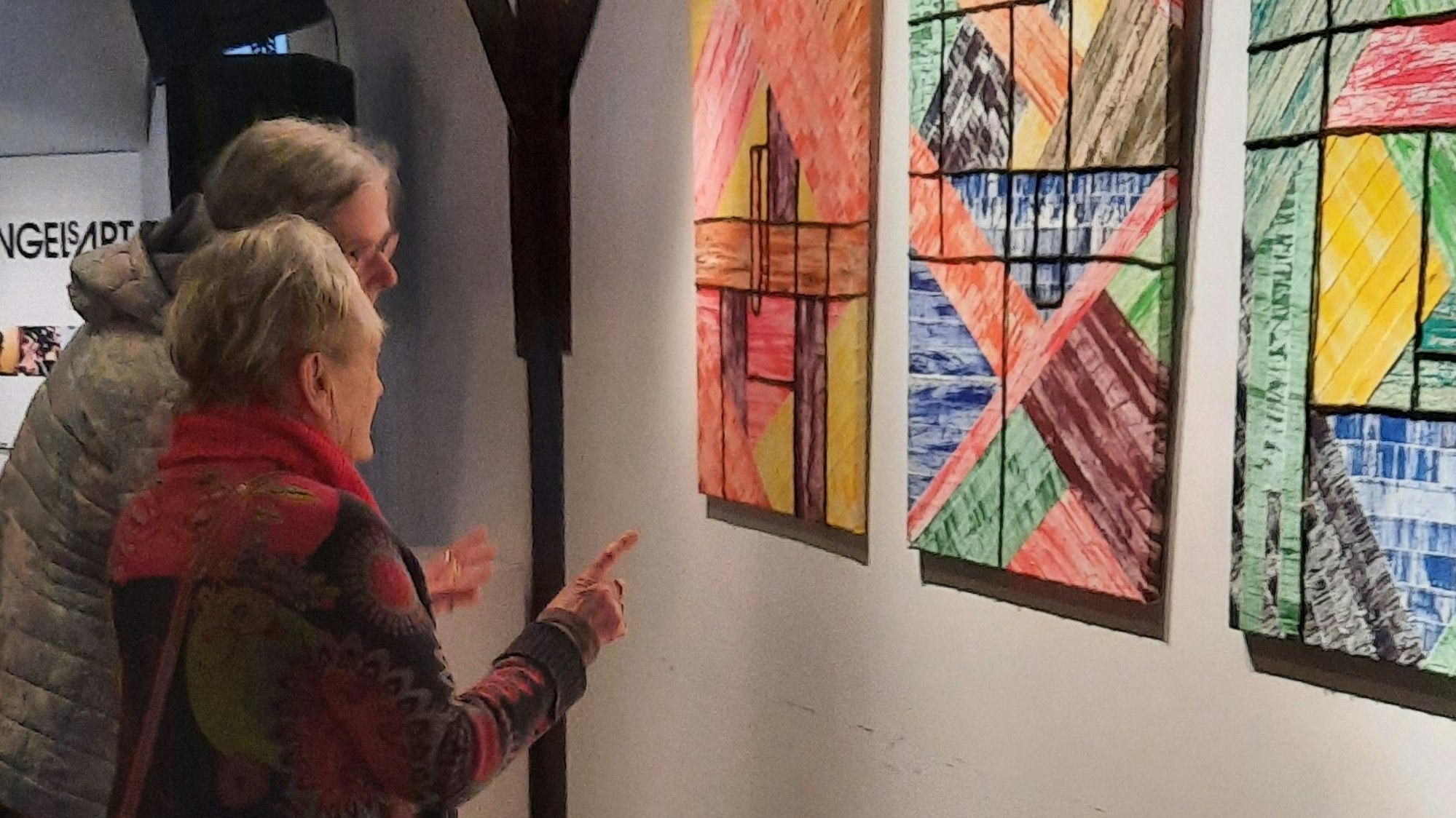 Zwei Frauen stehen vor Bildern.