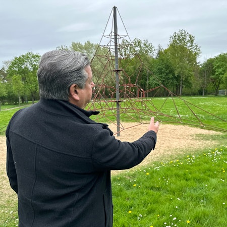 Mark Knülle zeigt auf den Spielplatz. Das Hastag-Park wurde auf einer alten Hausmüllkippe angelegt. Jetzt gibt es Senken im Boden.