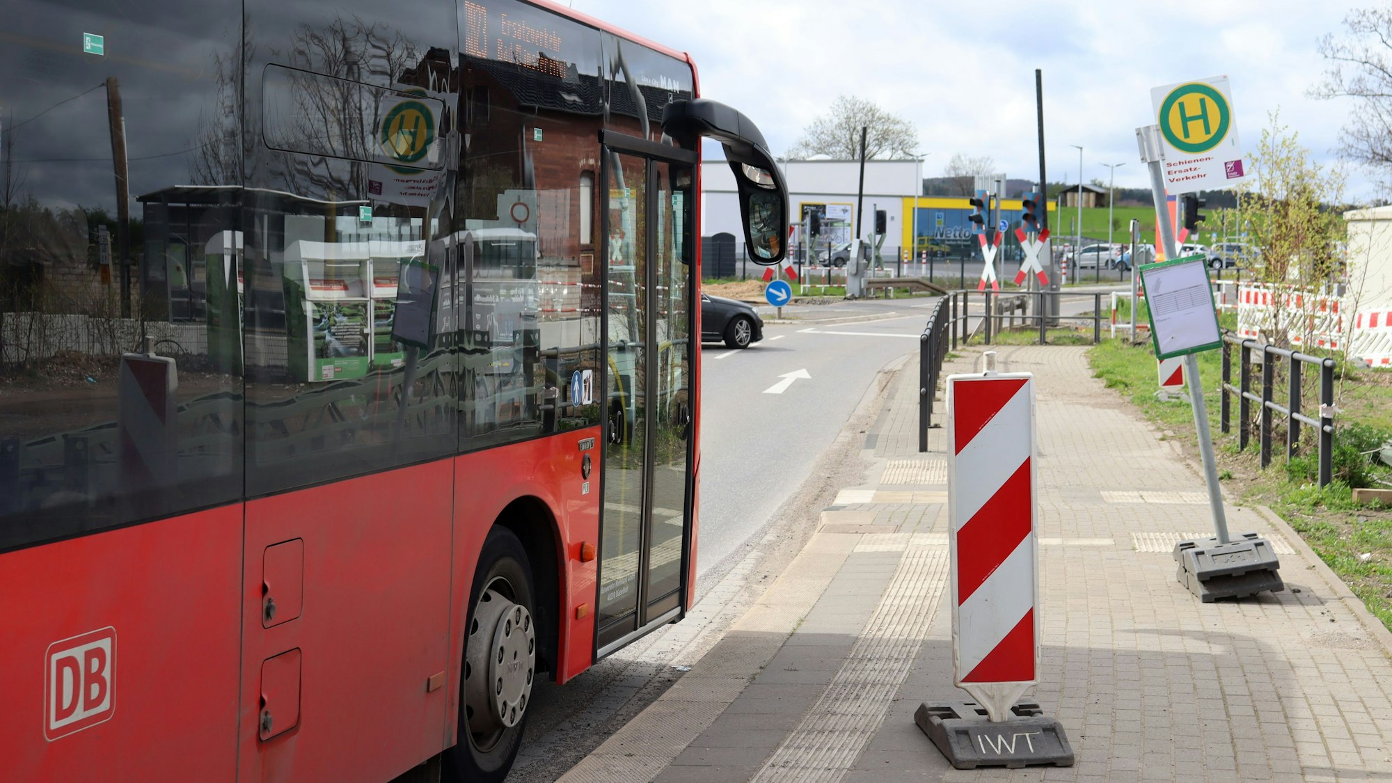 Ein Bus der Deutschen Bahn hält an einem Haltestellenschild am Arloffer Bahnhof.