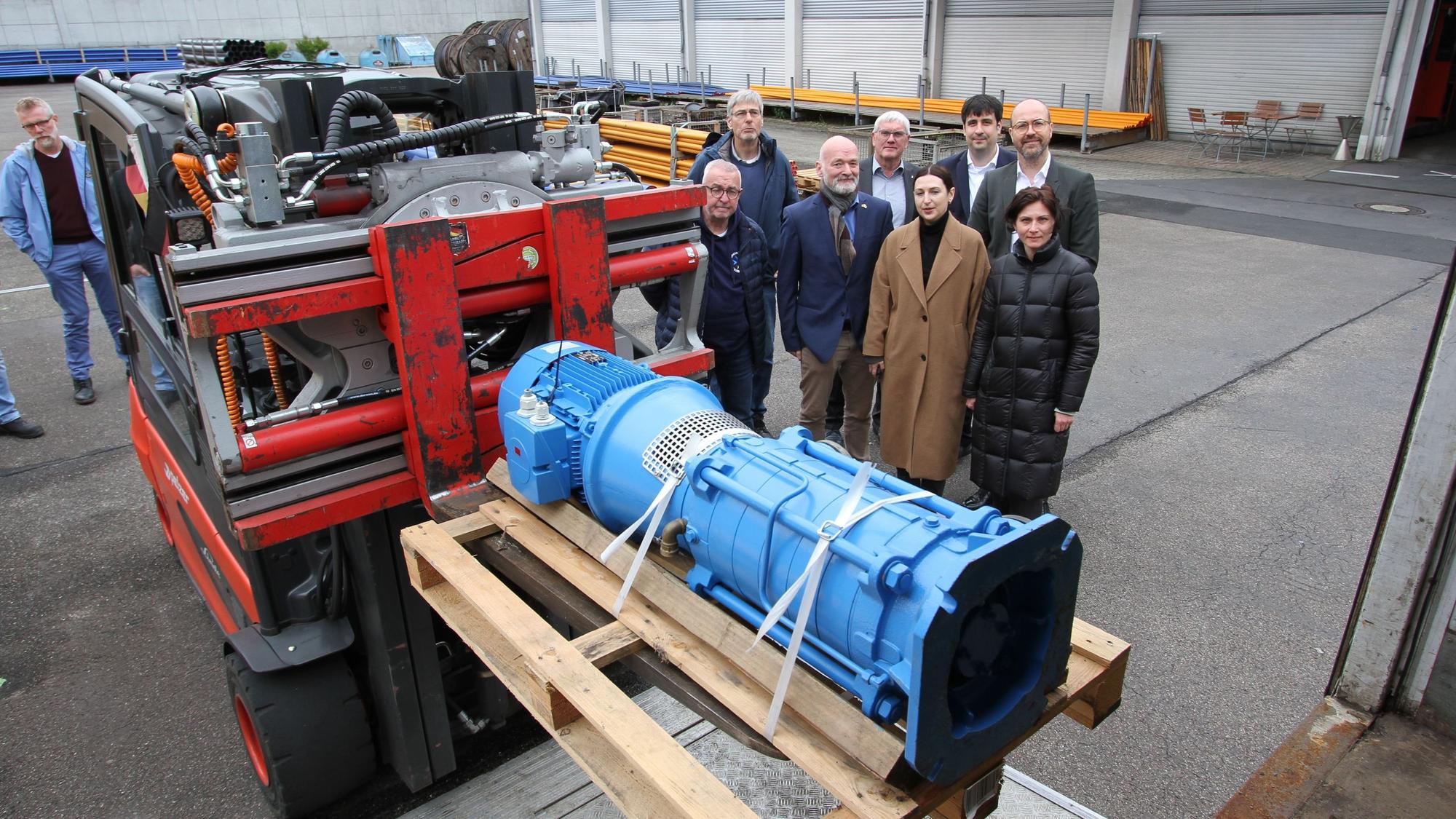 Ein Gabelstapler lädt eine blau lackierte Pumpe in einen Lastwagen
