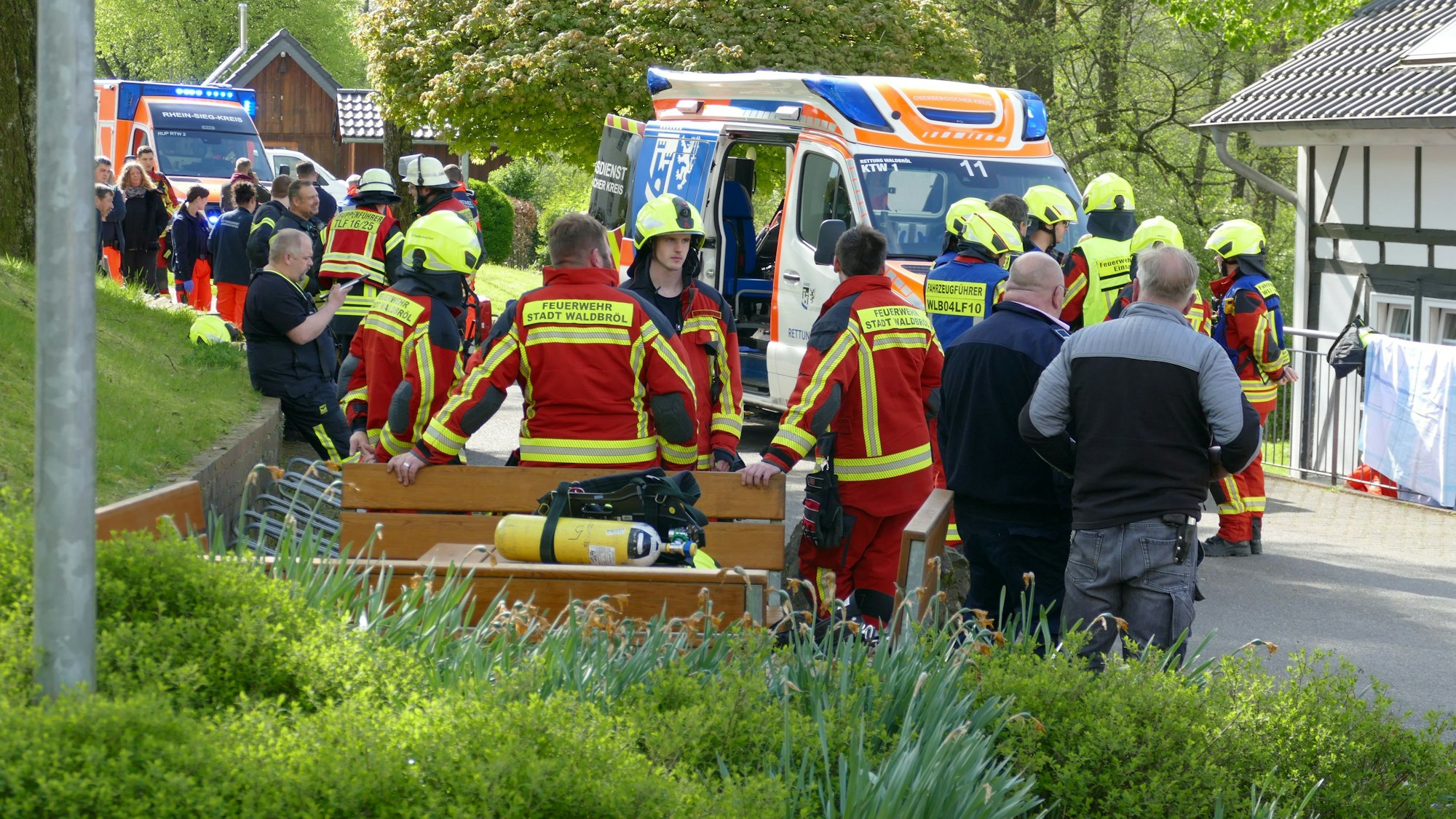 Rettungskräfte stehen vor dem betroffenen Gebäude in der Waldbröler Ortschaft Pulvermühle. Dort war ein Mensch ums Leben gekommen.