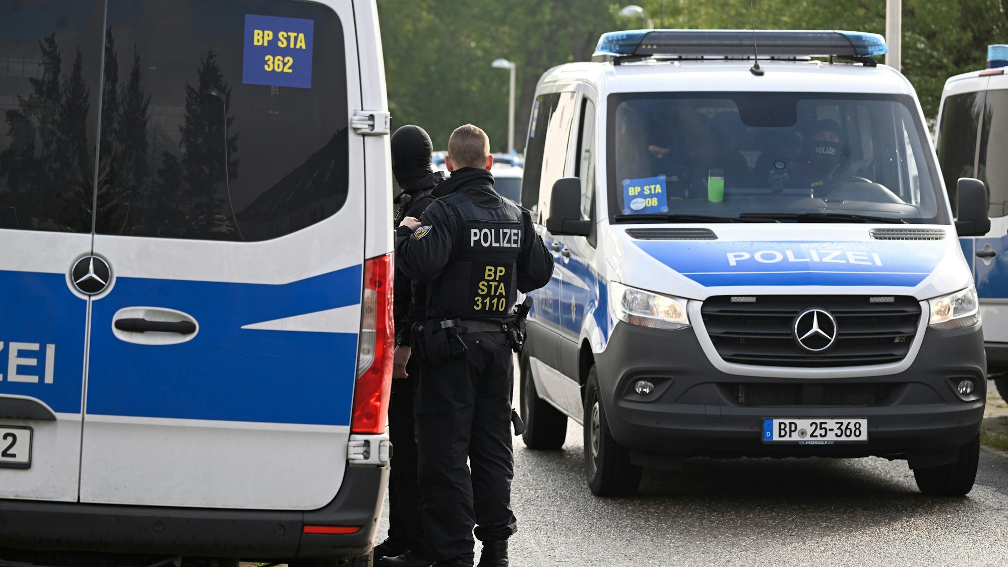 Das Bild zeigt mehrere Einsatzfahrzeuge der Polizei.