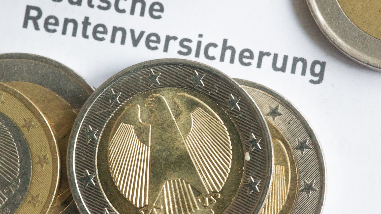 Münzen liegen auf einer Renteninformation der Deutschen Rentenversicherung.