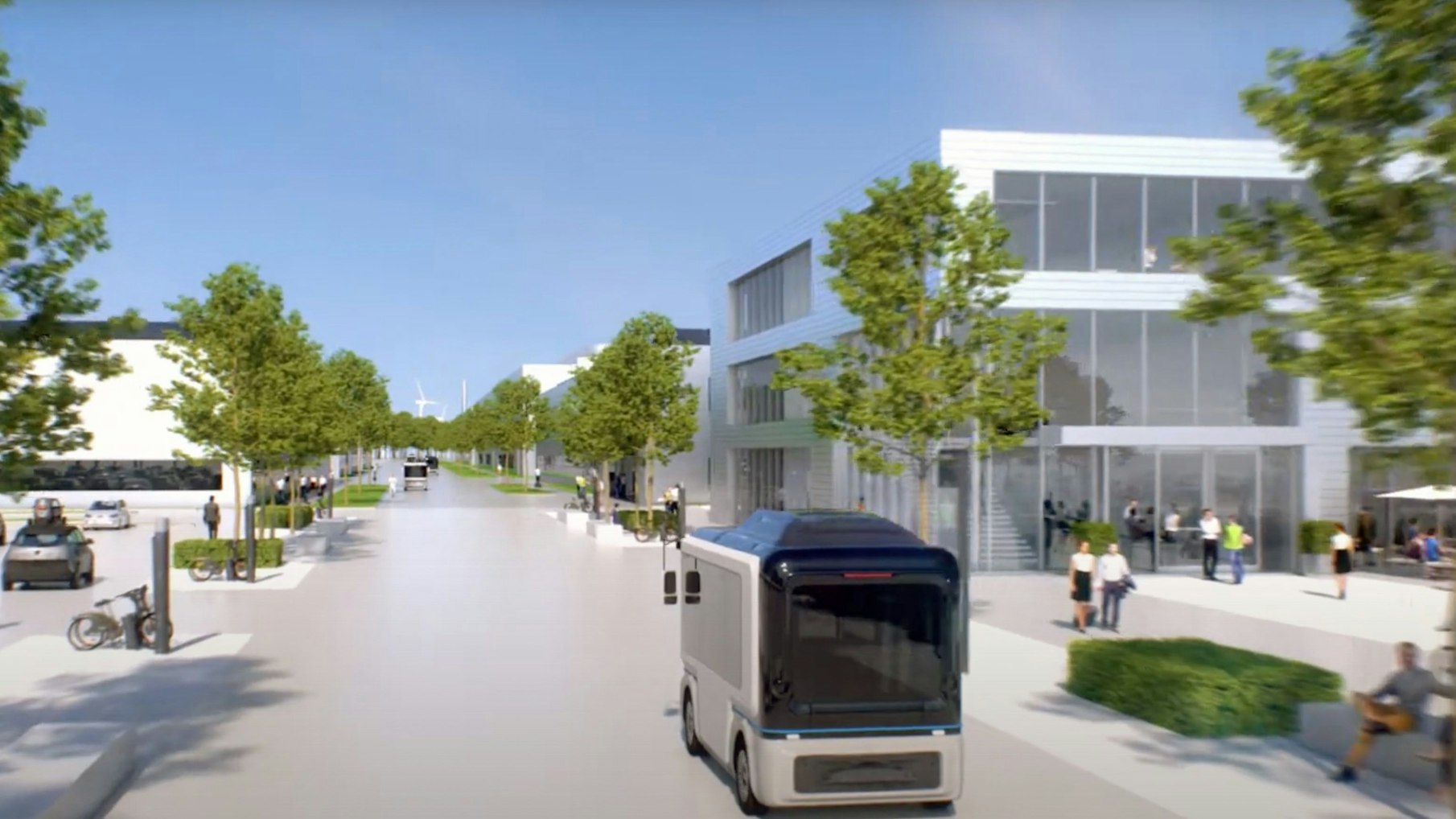 Das Bild zeigt einen Blick auf den Campus, Im Vordergrund fährt ein Bus.