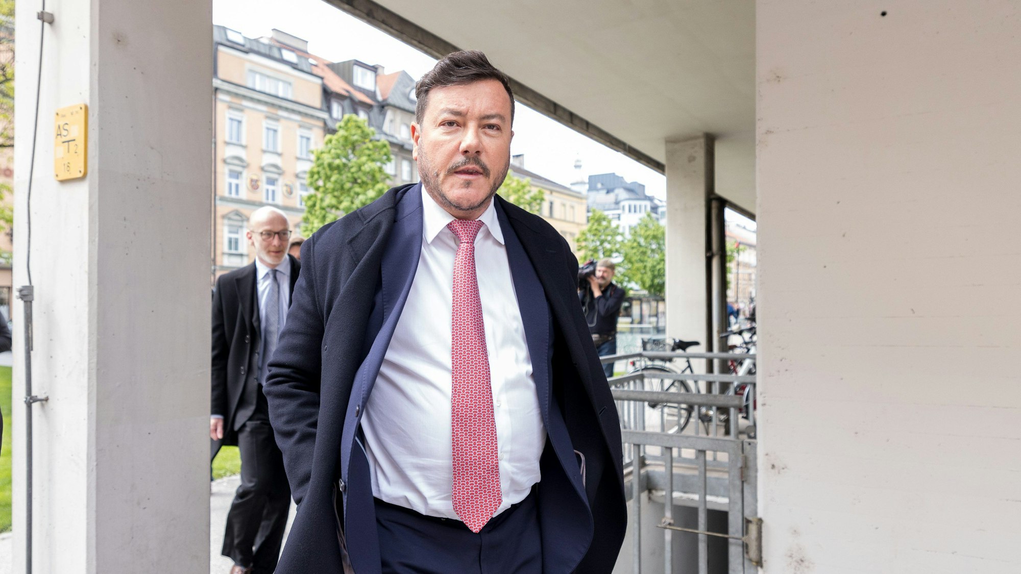 Österreich, Innsbruck: René Benko trägt eine rosafarbene Krawatte und blickt in die Kamera.