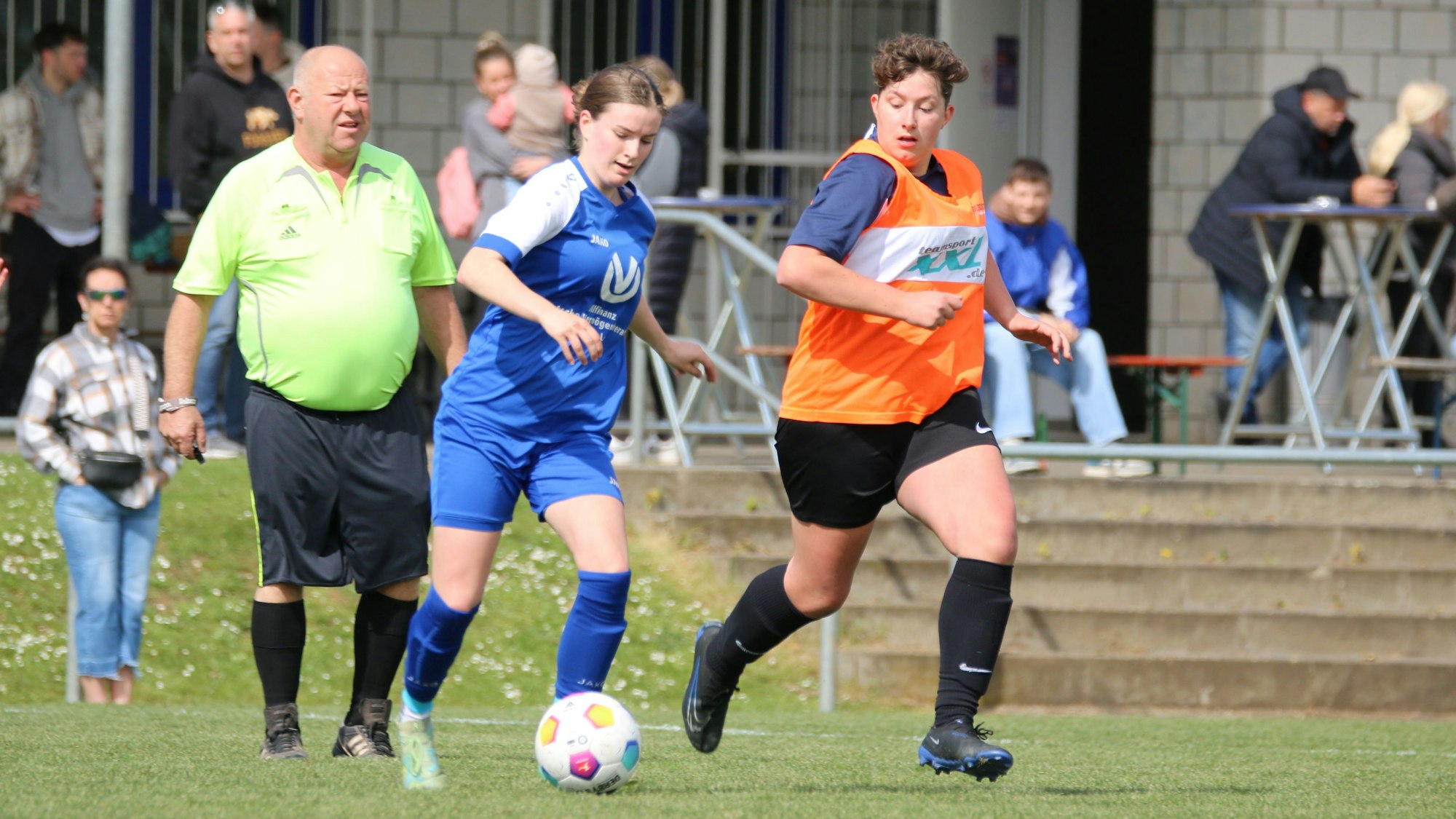 Der Schiedsrichter beobachtet ein Laufduelle zweier Spielerinnen.