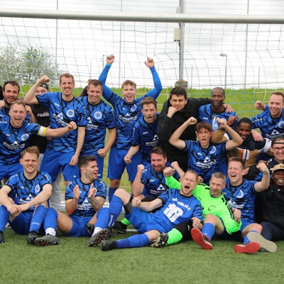 Gruppenbild der Sportfreunde D-H-O II, die über den Aufstieg jubeln.