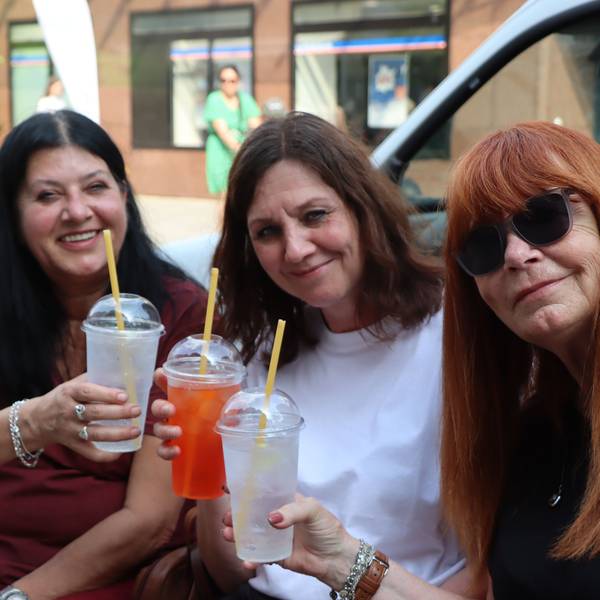 Zu sehen sind drei Besucherinnen, die einen Cocktail trinken.