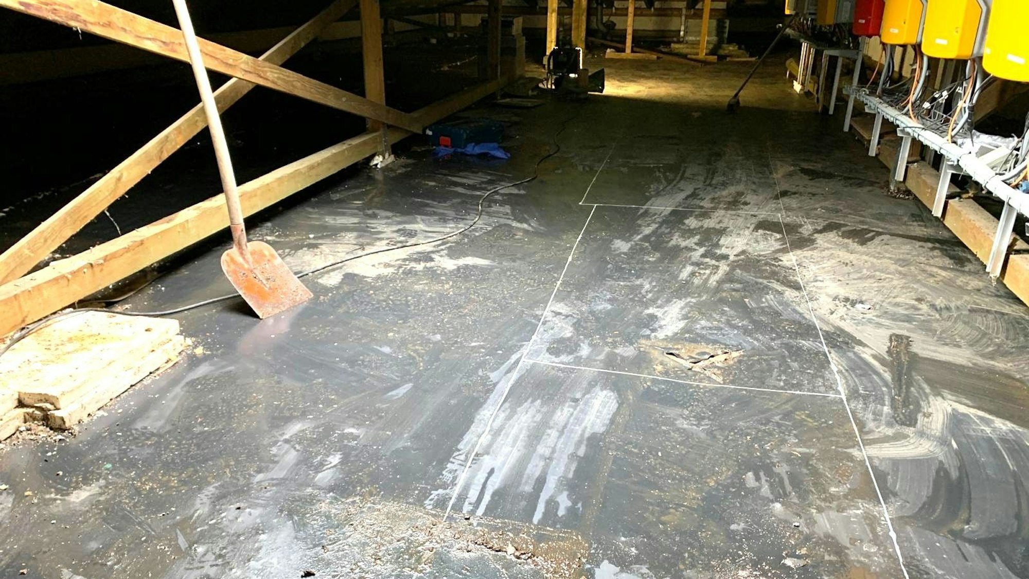 Blick auf den nassen Dachboden. Ein Rest Dämmung ist noch zu sehen.