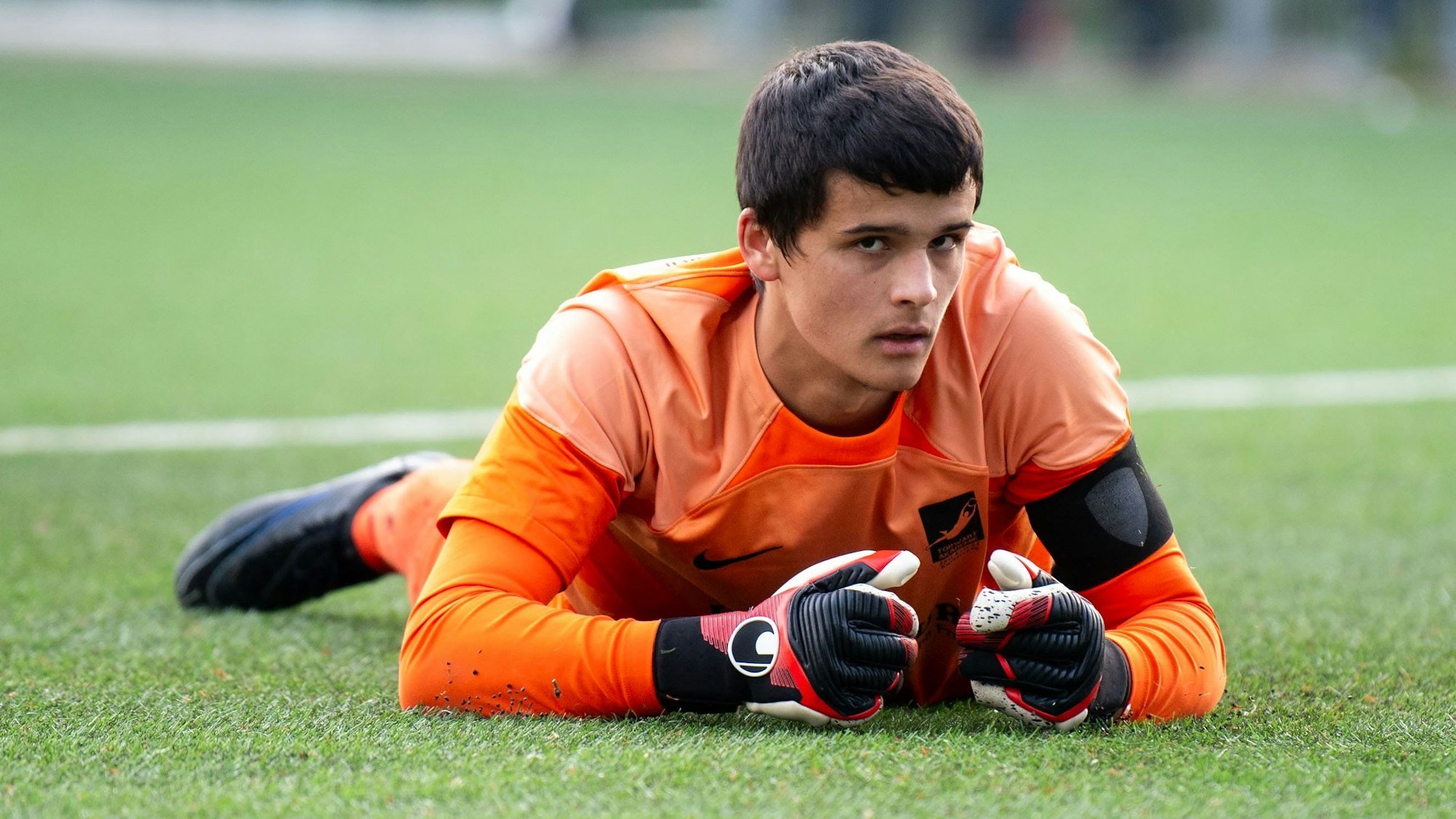 JSG-Torhüter Max Vonnahme liegt auf dem Fußballplatz in Kuchenheim am Boden.