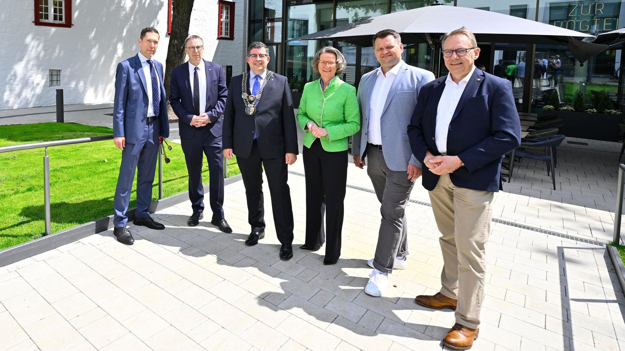 Blick auf eine Männergruppe mit Frau in der Mitte