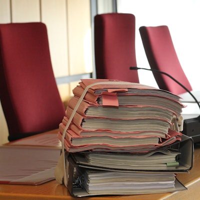 Auf einem Richtertisch im Amtsgericht Siegburg liegt ein Aktenstapel.