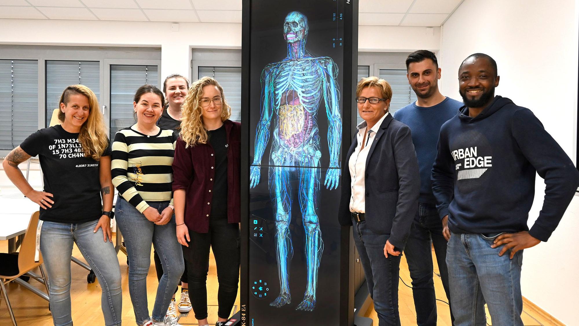 Auszubildende der Pflegeschule der Caritas Rhein-Erft mit dem neuen Anatomietisch.