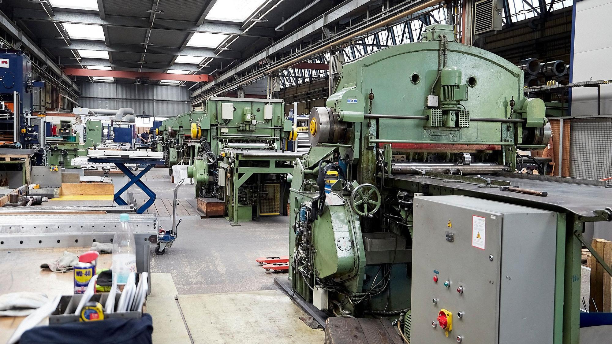 Das Bild zeigt einen Blick in eine der Produktionshallen von Hein, Lehmann in Nettersheim-Zingsheim, in der zahlreiche Maschinen stehen.
