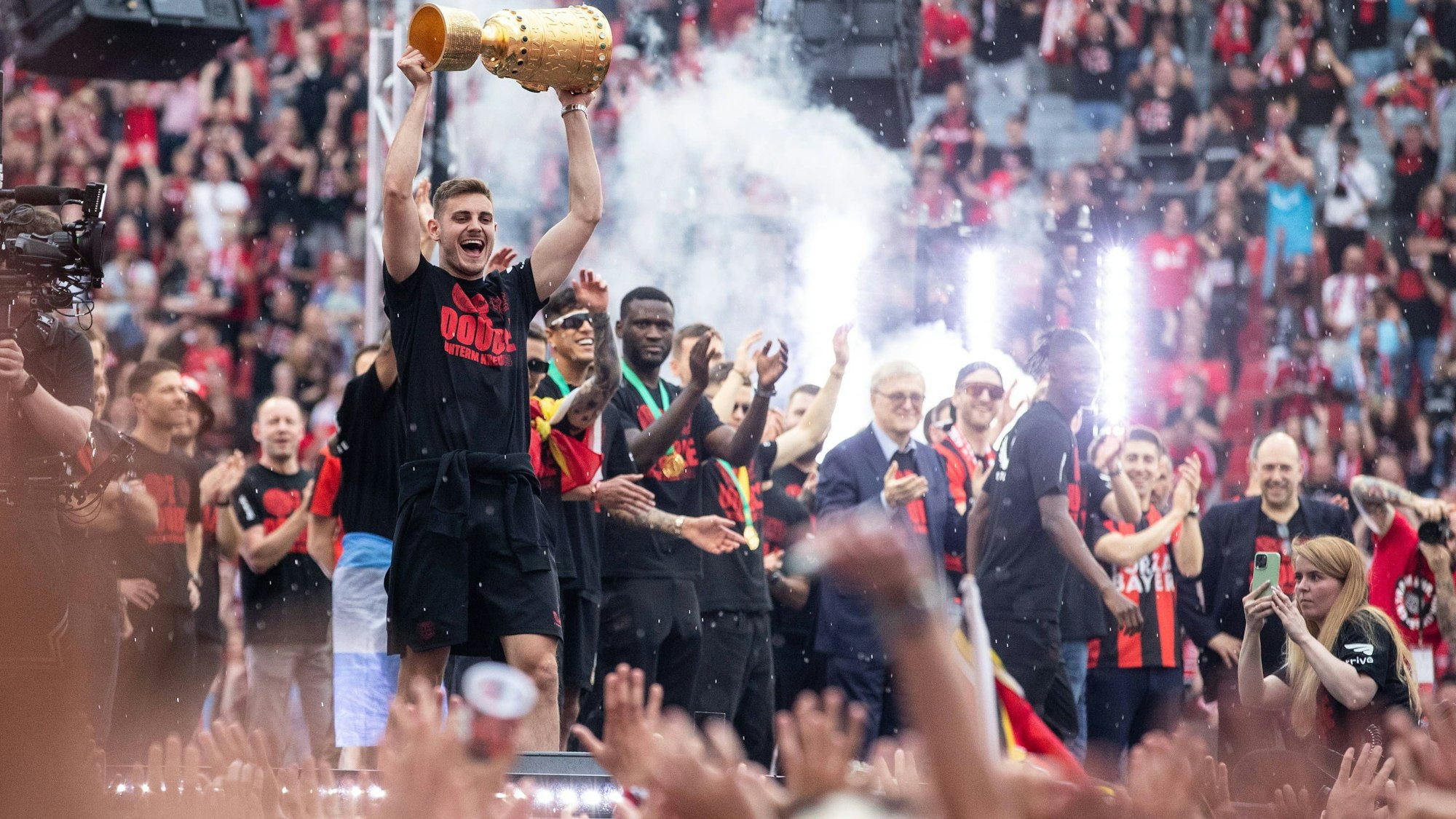 Begeisternder Empfang für den Double-Sieger in der BayArena: Josip Stanisic präsentiert den Fans den DFB-Pokal.