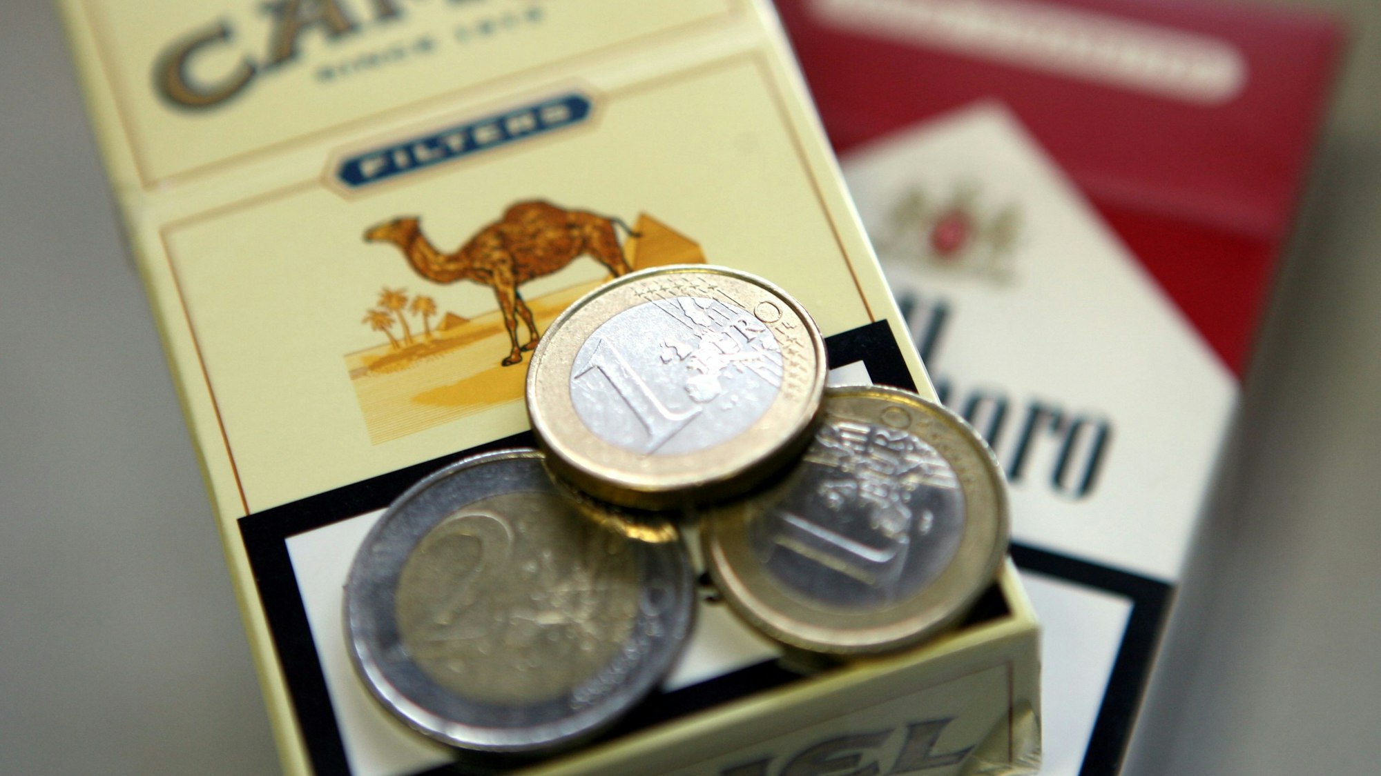 Vier Euro liegen auf einer Zigarettenschachtel (Symbolfoto).