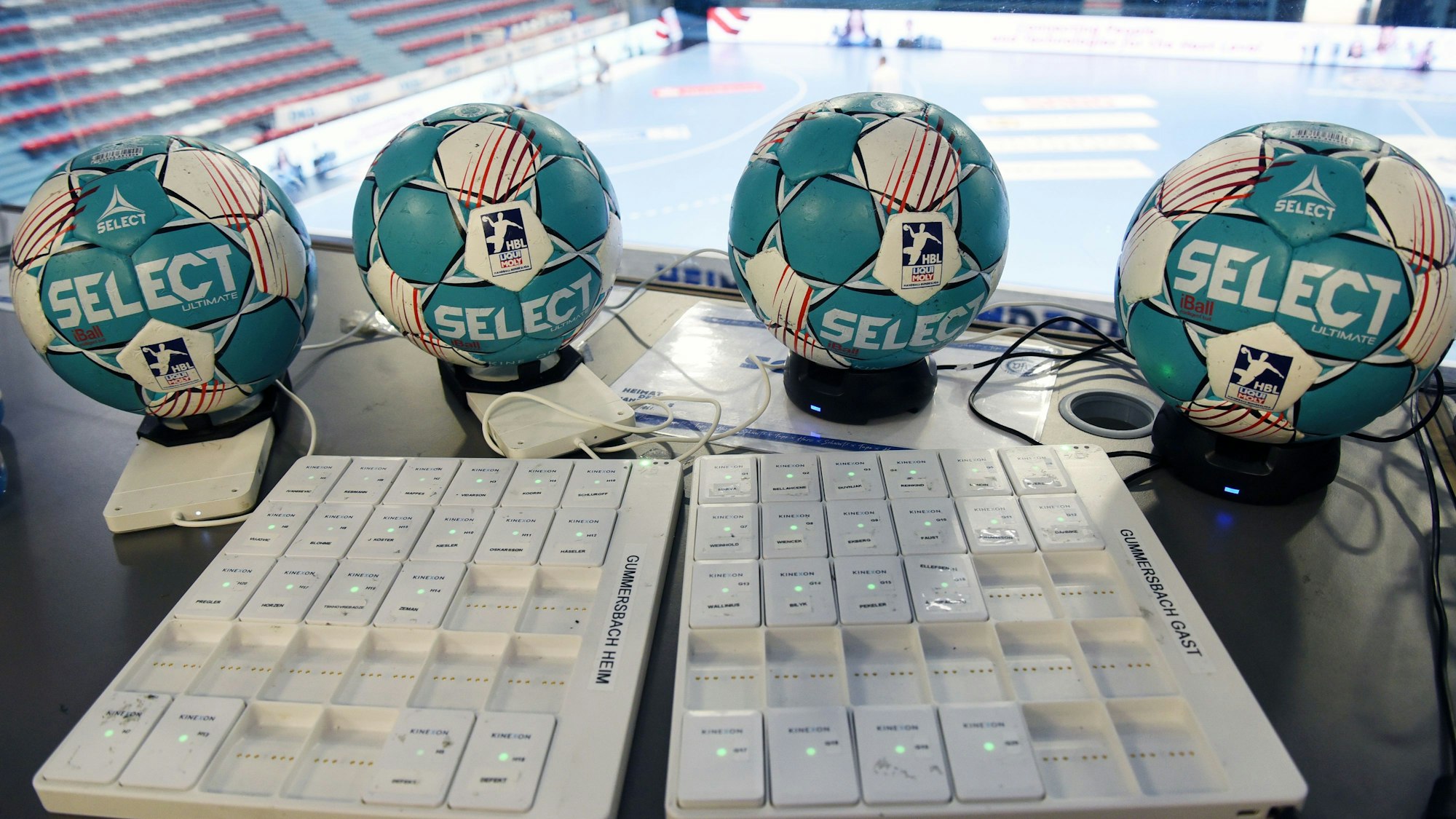Vier Handball-Spielbälle und ihre Sensoren werden geladen.