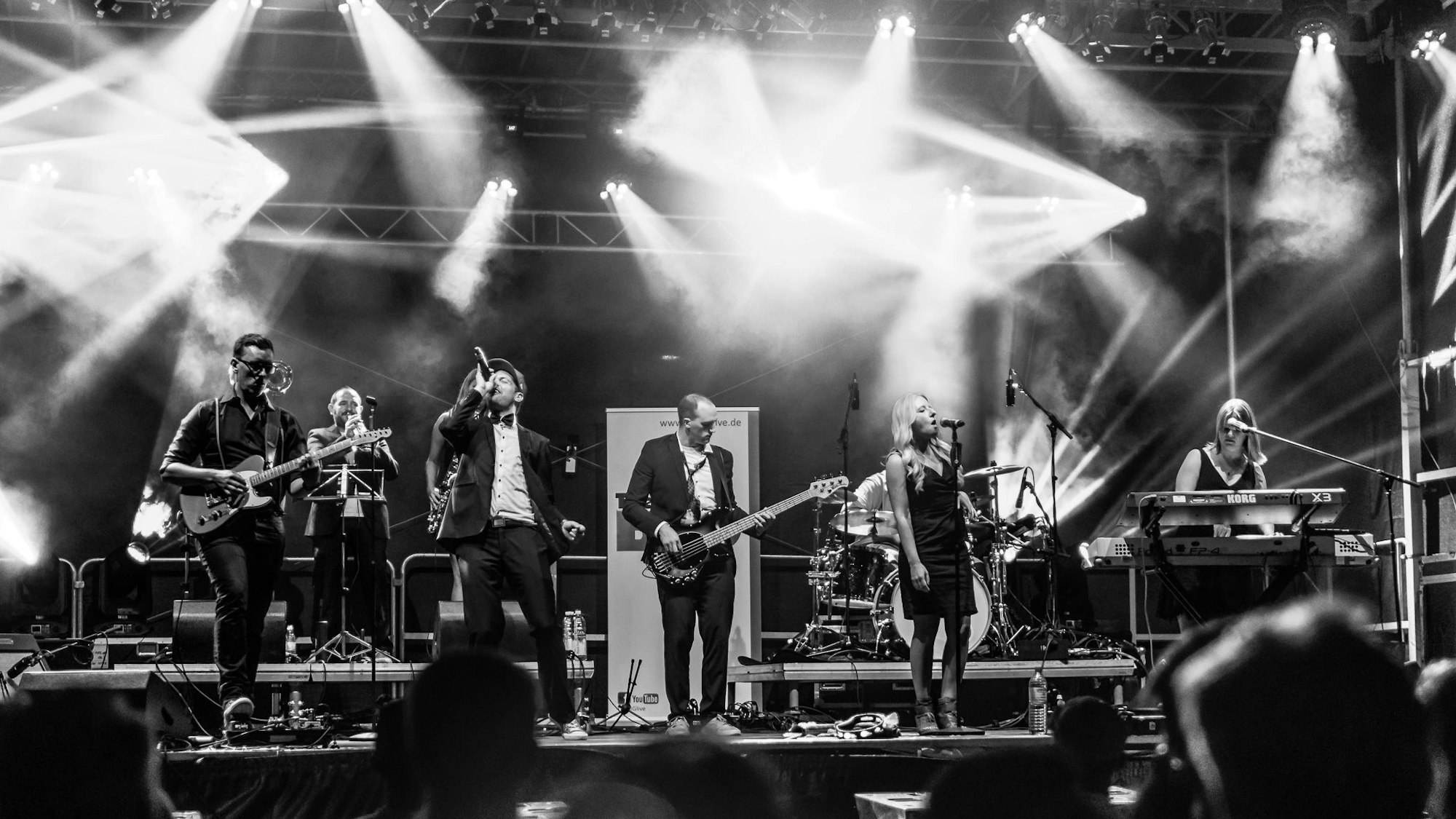 Eine Schwarzweiß-Aufnahme der Band auf der Bühne.