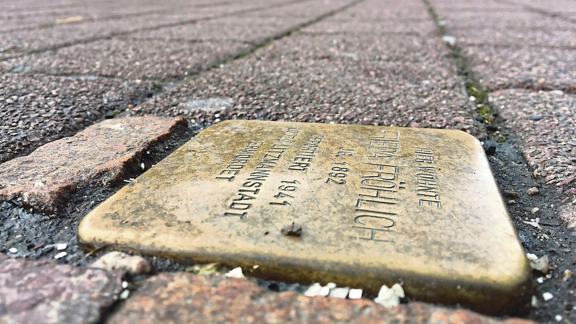 Auf dem Foto ist ein Stolperstein zu sehen.