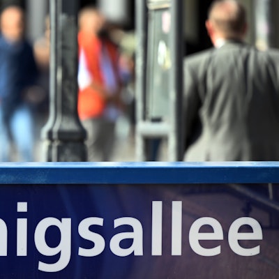 Menschen flanieren auf der Düsseldorfer Prachtstraße Königsallee.
