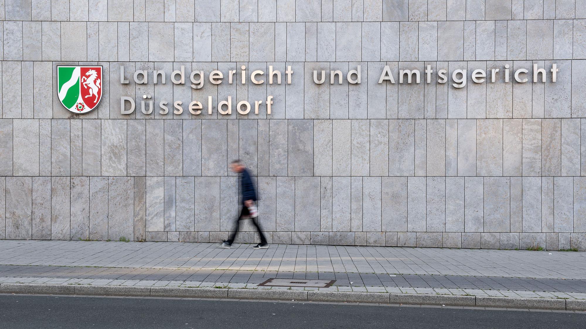 ARCHIV - 29.04.2019, Nordrhein-Westfalen, Düsseldorf: Ein Fußgänger geht am Amtsgericht Düsseldorf vorbei. (zu dpa: «Prozess um Tod einer Katze - vom Balkon gestoßen») Foto: Marius Becker/dpa +++ dpa-Bildfunk +++