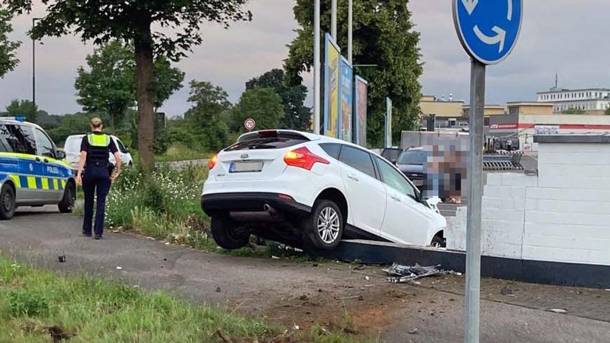 Das Bild zeigt ein weißes Auto, das gegen eine Mauer geprallt war.
