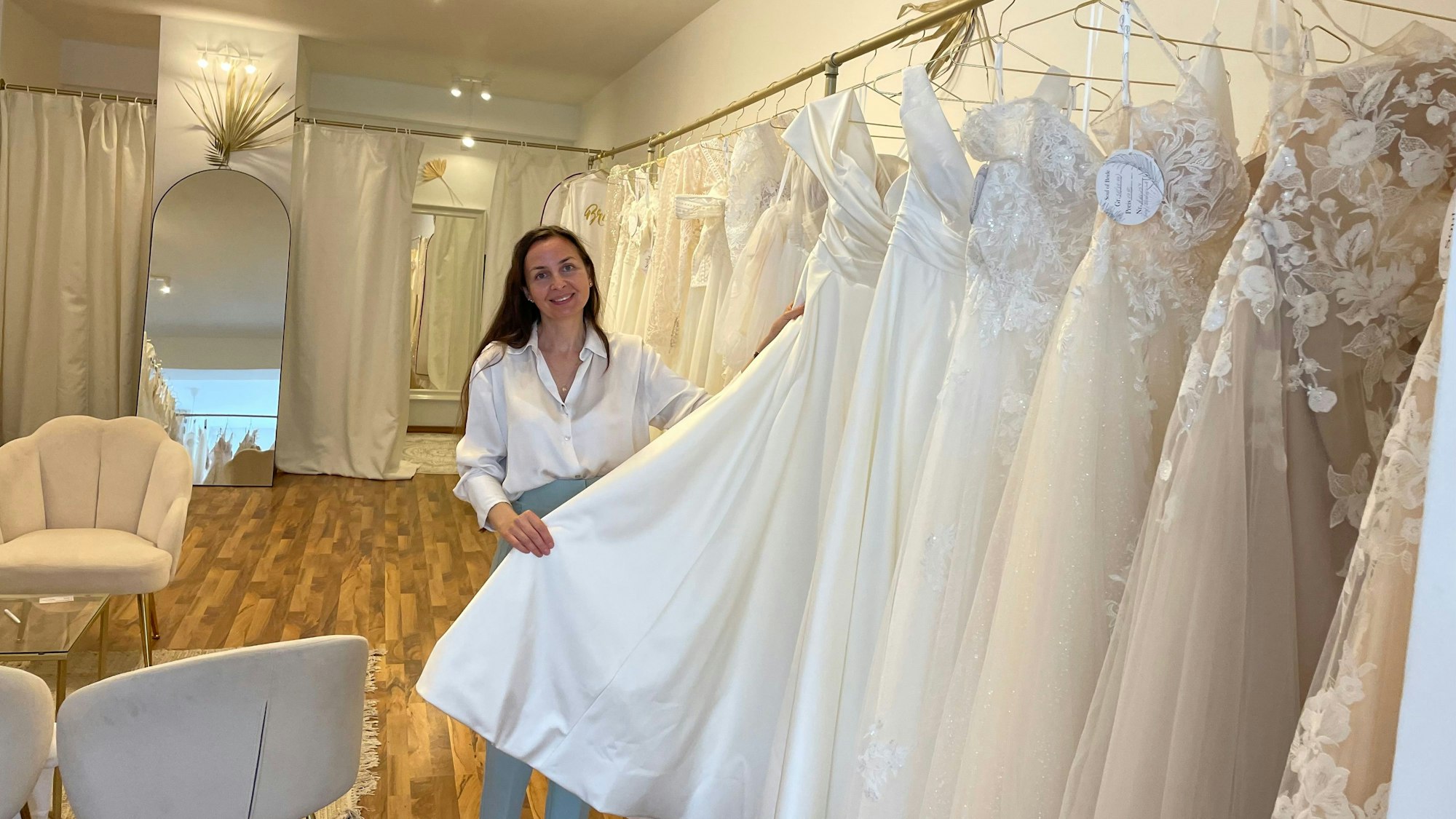 Besitzerin Kseniya Reyda steht in ihrem neuen Laden vor den Brautkleidern.