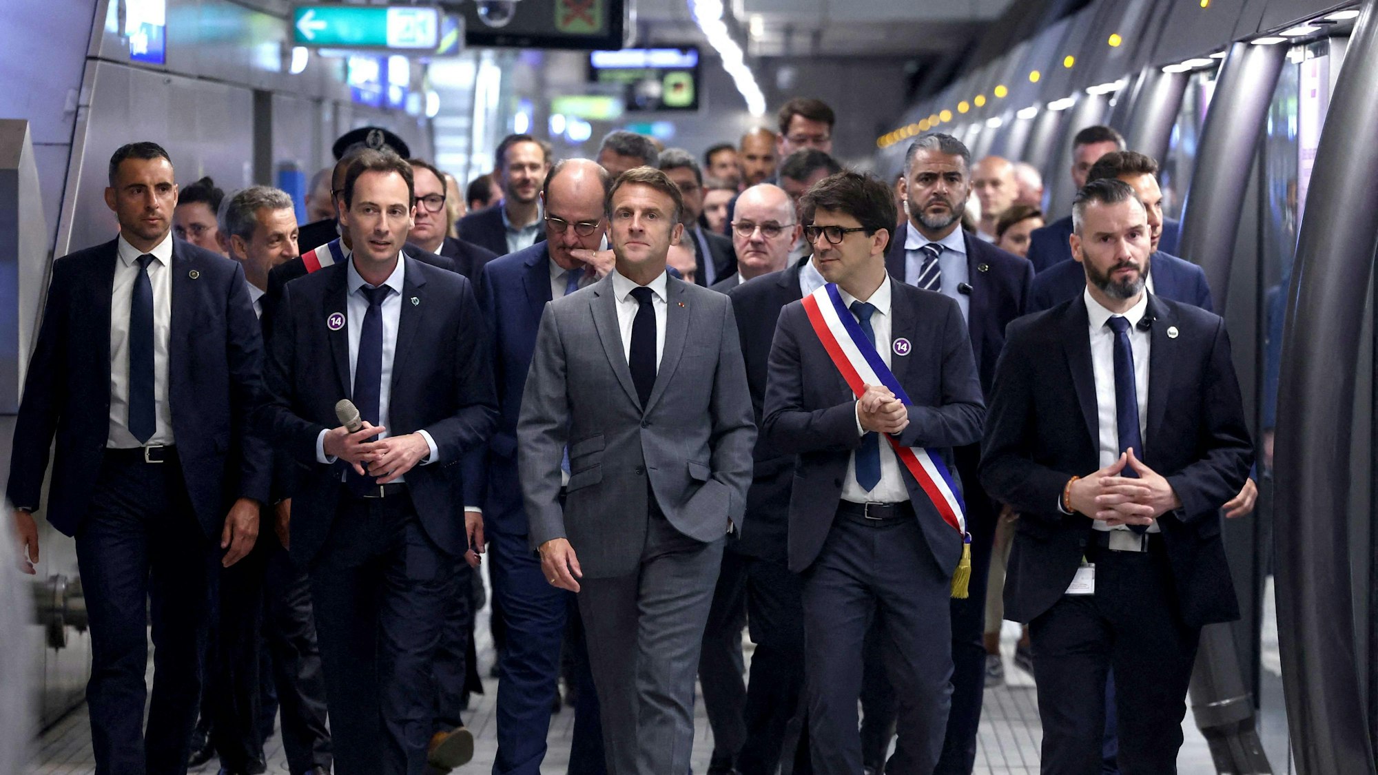 Der französische Präsident Macron (m) bei der Einweihung eines neuen Abschnittes der Pariser U-Bahnlinie 14.