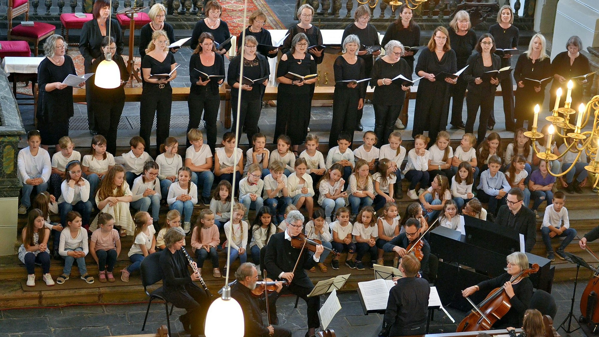 Sängerinnen und Sänger sowie Instrumentalisten werden gezeigt.