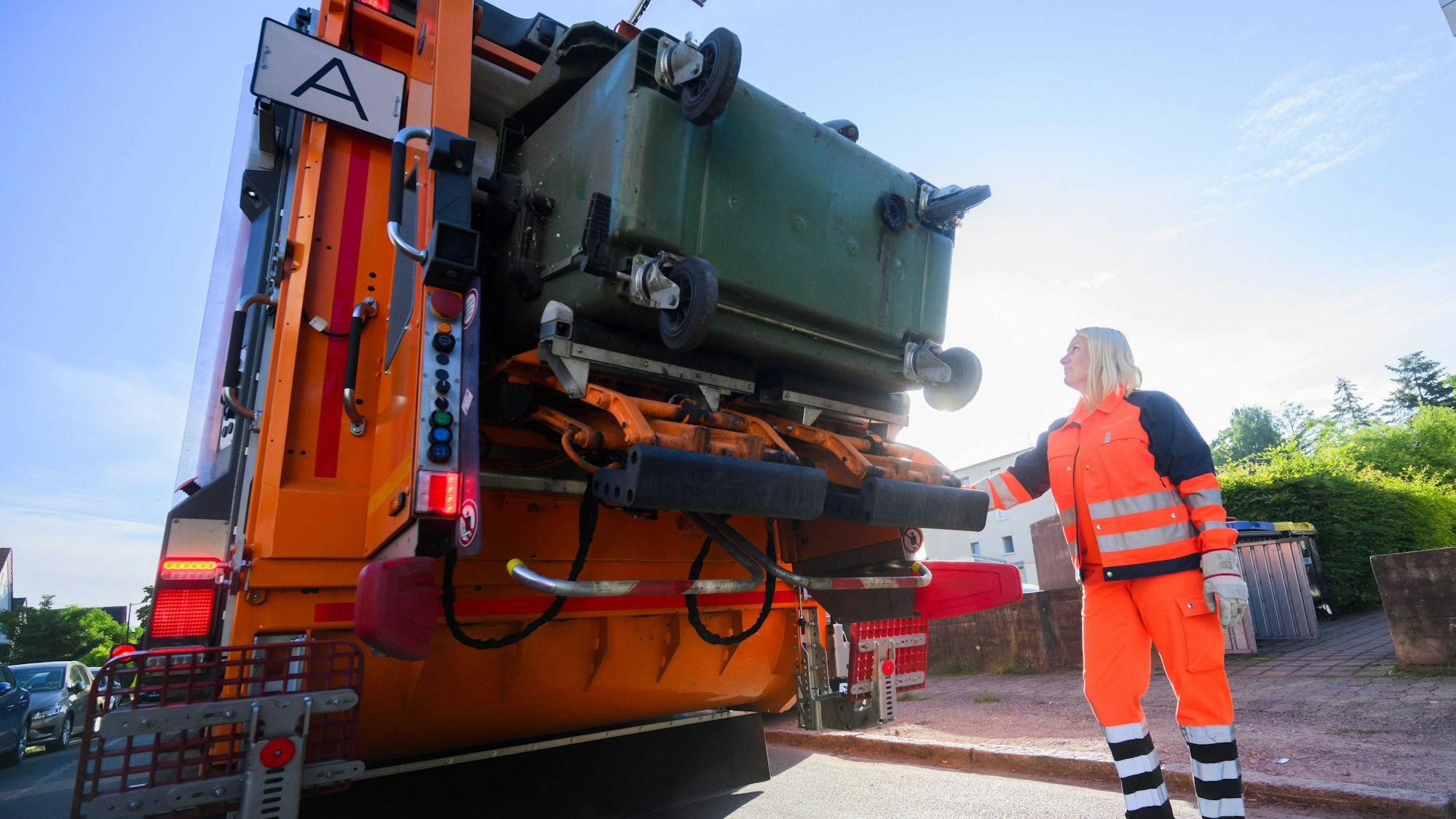Eine Mülltonne wird geleert.