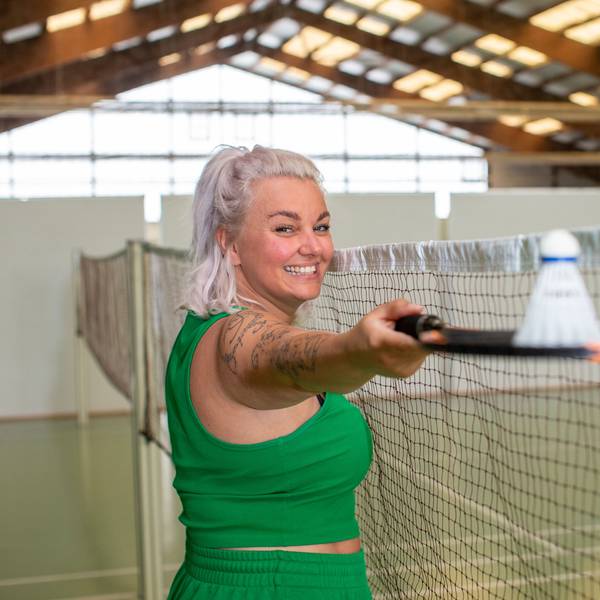 Nici Kempermann steht in der Badminton-Halle des Sportcenter Kautz mit einem Badminton-Schläger in der Hand.