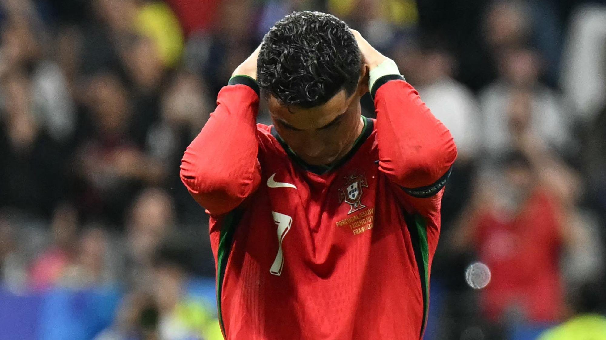 TOPSHOT - Portugal's forward #07 Cristiano Ronaldo reacts after failing to score a penalty kick during the UEFA Euro 2024 round of 16 football match between Portugal and Slovenia at the Frankfurt Arena in Frankfurt am Main on July 1, 2024. (Photo by PATRICIA DE MELO MOREIRA / AFP)