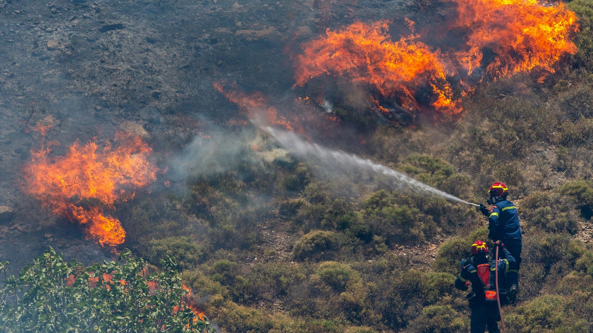 Feuerwehrleute versuchen ein Feuer im Wald von Keratea, südöstlich von Athen, Griechenland, zu löschen.