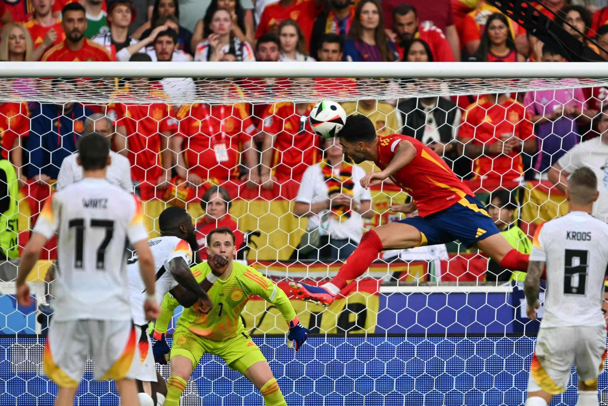 TOPSHOT - Spain's midfielder #06 Mikel Merino (CR) heads the ball and scores his team's second goal during the UEFA Euro 2024 quarter-final football match between Spain and Germany at the Stuttgart Arena in Stuttgart on July 5, 2024. (Photo by Fabrice COFFRINI / AFP)