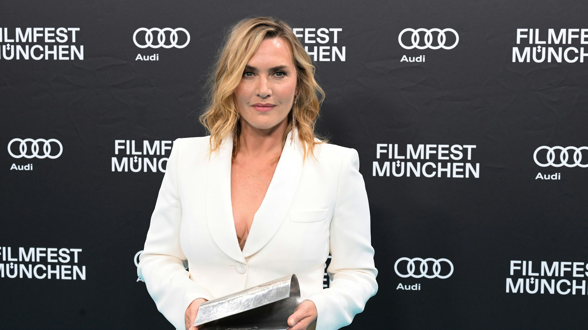 Oscar-Preisträgerin Kate Winslet steht im Rahmen des Filmfest München bei der Verleihung des CineMerit Award im Deutschen Theater mit dem CineMerit Award auf dem türkisen Teppich.