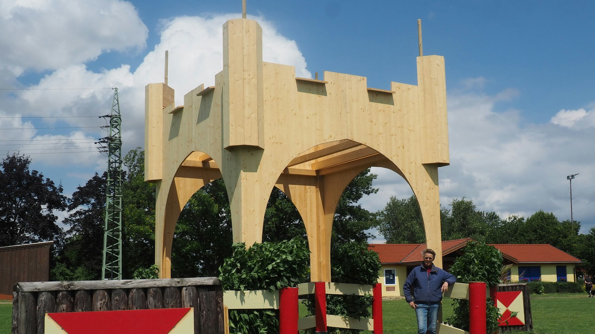 Dorit Santema steht am Medardus-Tor, einer imposanten Holzkonstruktion auf dem Gelände des Vereins.