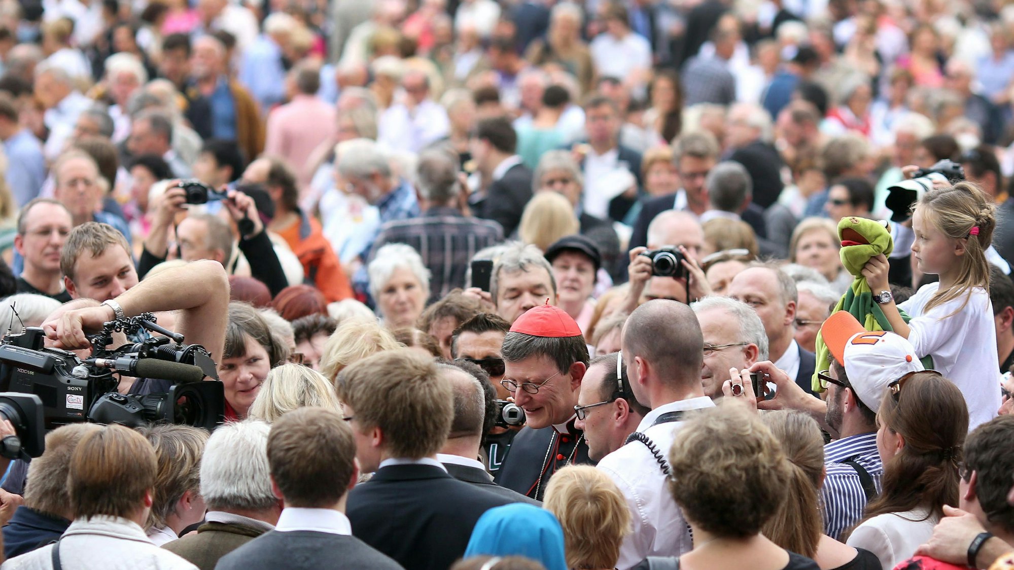 Rainer Maria Kardinal Woelki wird auf dem Roncalliplatz nach dem Festgottesdienst von tausenden Gläubigen umlagert.