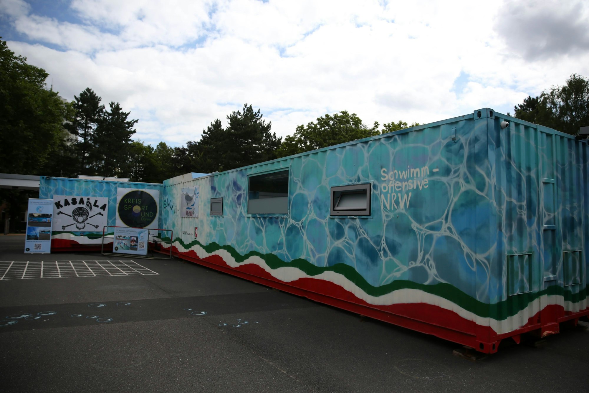 Ein Schwimmcontainer steht auf einem Platz.