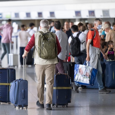 Passagiere warten auf dem Flughafen auf ihren Check-In.