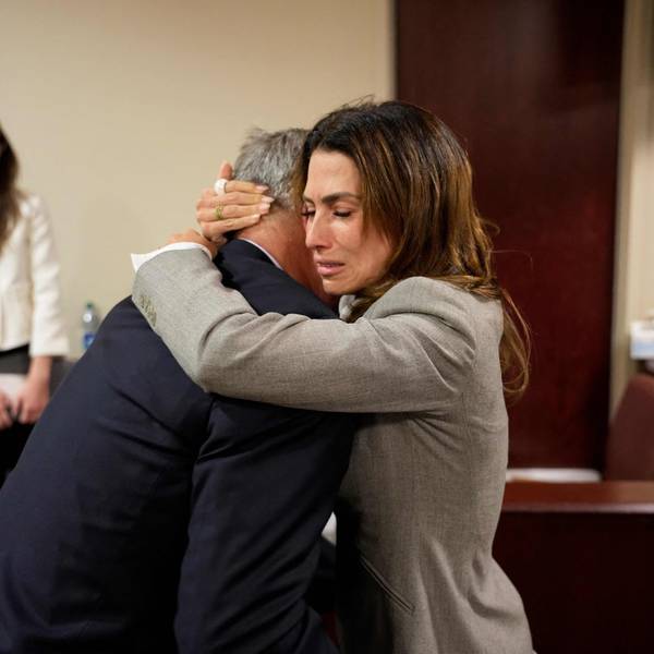 US actor Alec Baldwin and his wife Hilaria Baldwin embrace during his trial on involuntary manslaughter at Santa Fe County District Court in Santa Fe, New Mexico, on July 12, 2024. Baldwin's trial for involuntary manslaughter was dismissed by a judge Friday after she ruled that key evidence over a fatal shooting on the set of "Rust" had been withheld from the defense. (Photo by Ramsay de Give / POOL / AFP)