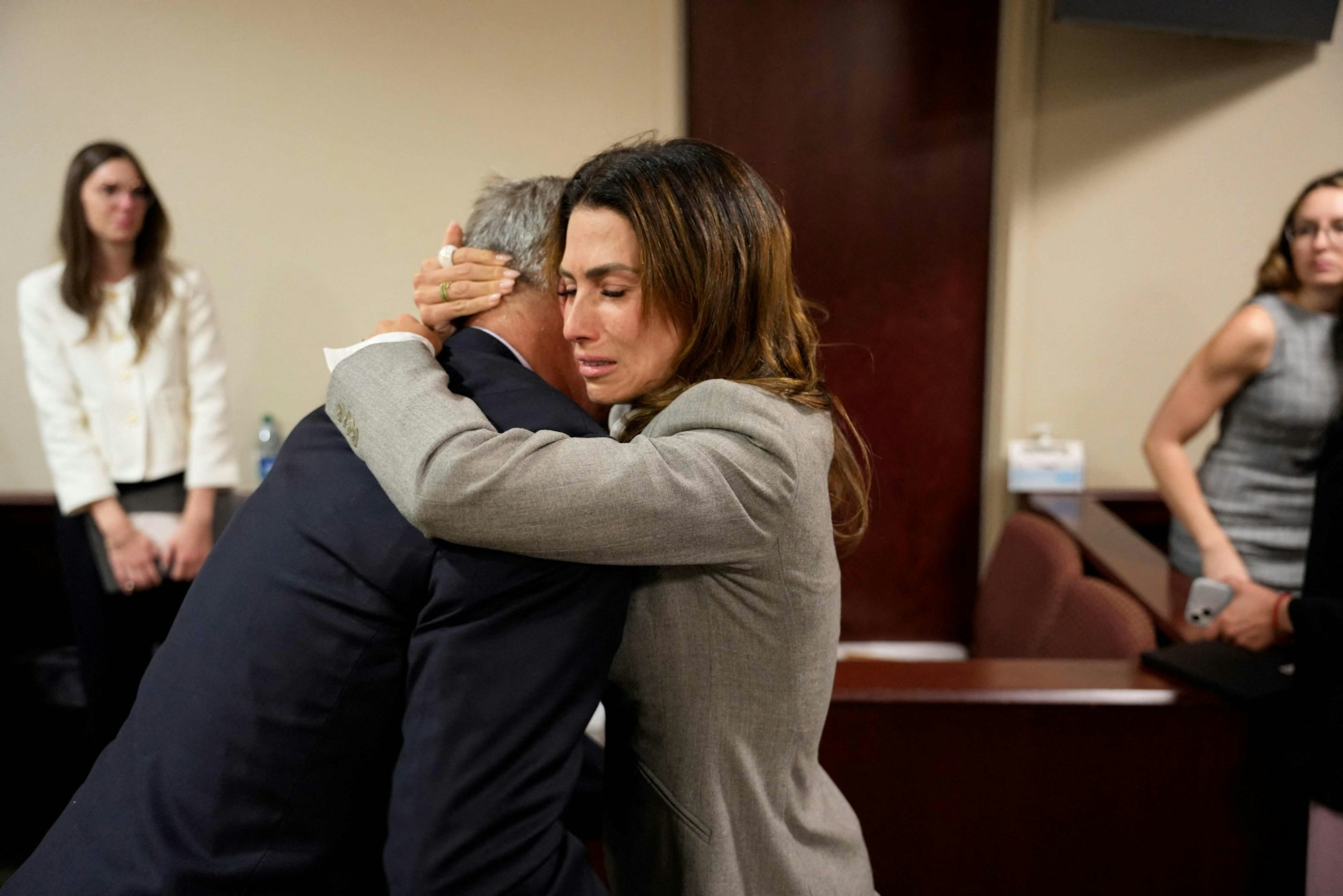 US actor Alec Baldwin and his wife Hilaria Baldwin embrace during his trial on involuntary manslaughter at Santa Fe County District Court in Santa Fe, New Mexico, on July 12, 2024. Baldwin's trial for involuntary manslaughter was dismissed by a judge Friday after she ruled that key evidence over a fatal shooting on the set of "Rust" had been withheld from the defense. (Photo by Ramsay de Give / POOL / AFP)