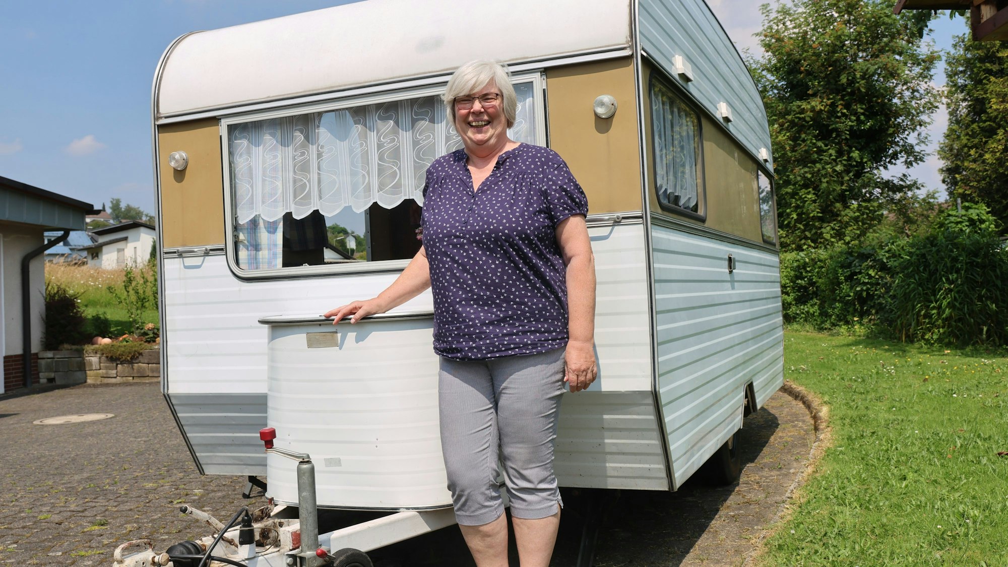 Elke Hartmann steht vor ihrem Wohnwagen.