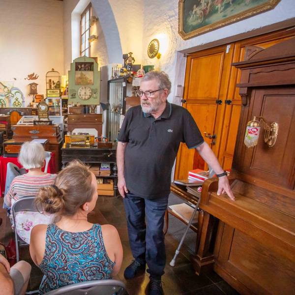 Das Foto im Drehorgelmuseum zeigt Museumsleiter Ullrich Wipper und mehrere Zuhörer.