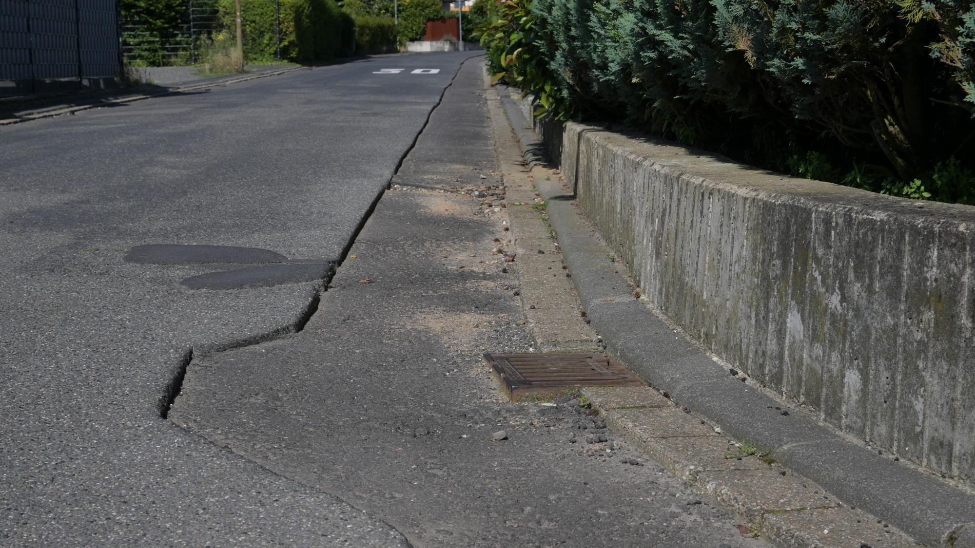 Die Asphaltdecke etlicher Straßen im Rösrather Ortsteil Kleineichen ist nach dem Verlegen von Glasfaser-Leitungen nur unzureichend wiederhergestellt. Durch die provisorische Abdeckung sind Schlaglöcher entstanden, Gullydeckel ragen zentimeterhoch hervor.