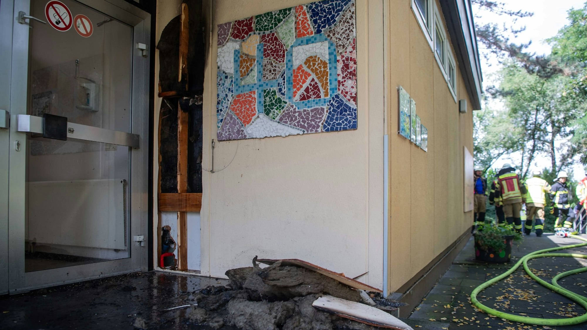 Das Bild zeigt Dämmmaterial, das am Eingang der Kita liegt. Die Feuerwehr hat Teile der Fassade aufgeschnitten.