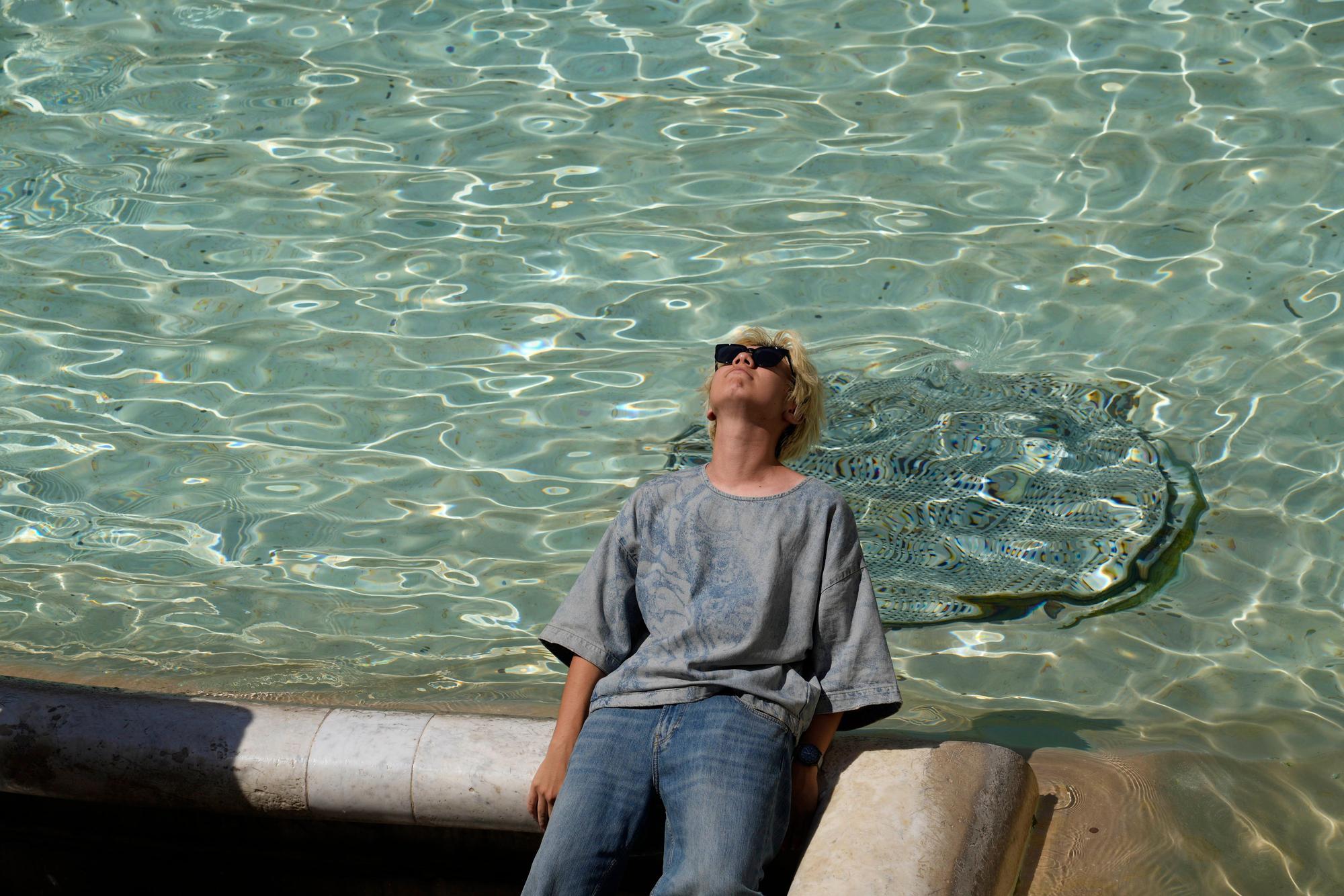 Italien, Rom: Ein Mann sitzt am Trevi-Brunnen. (Symbolbild)