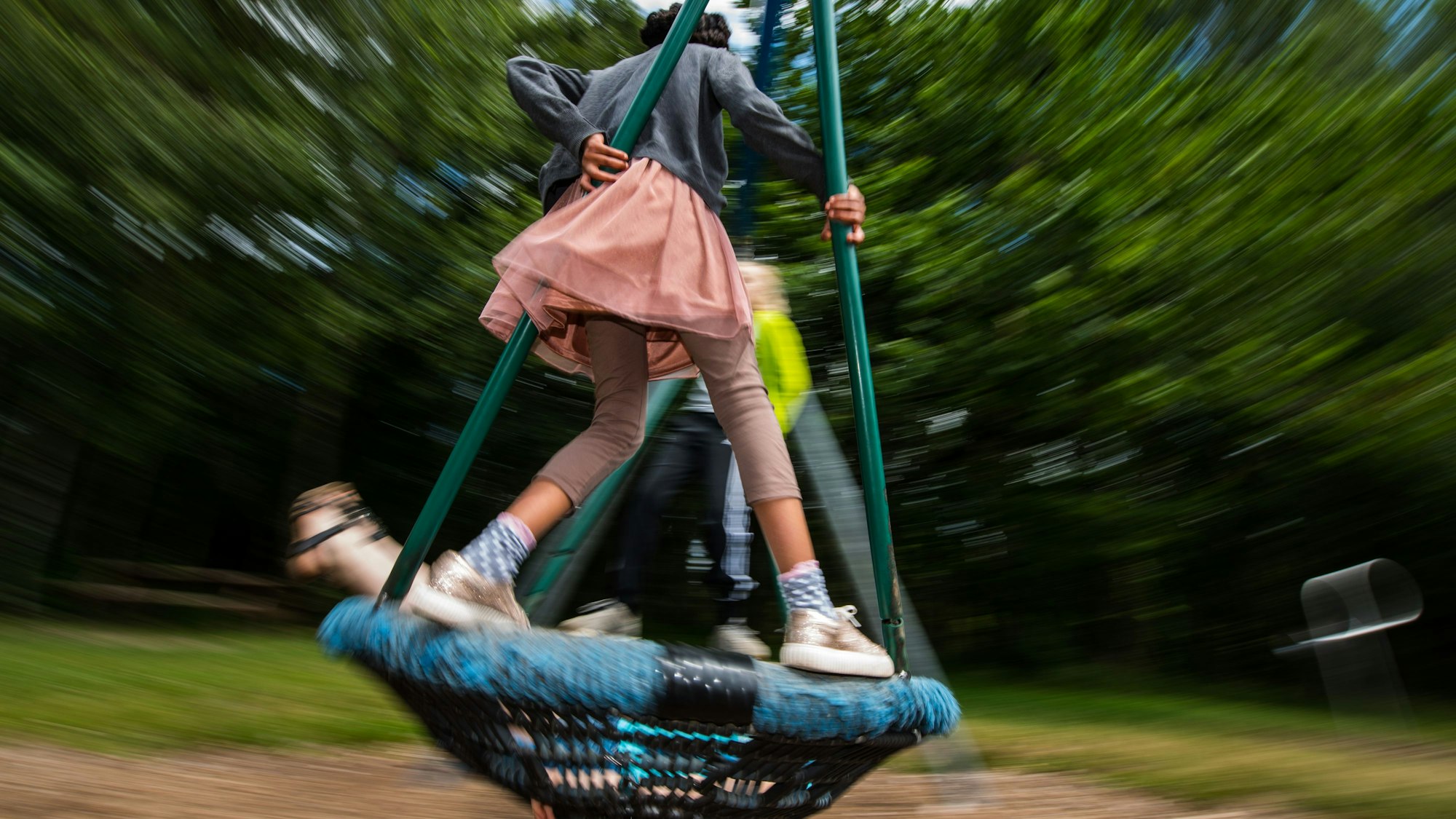 Ein paar Kinder sind auf einer Affenschaukel.