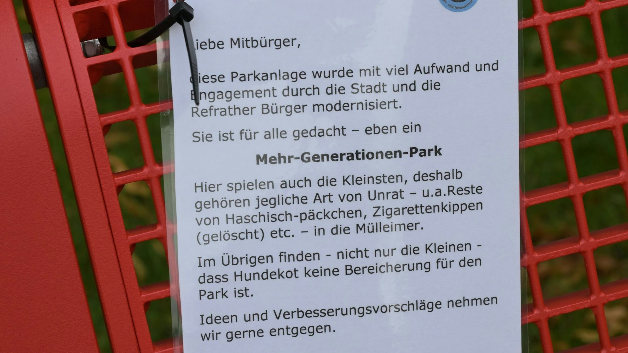 Mehrgenerationenpark Refrath: Zettel mit Ermahnung hängt an einer Bank.