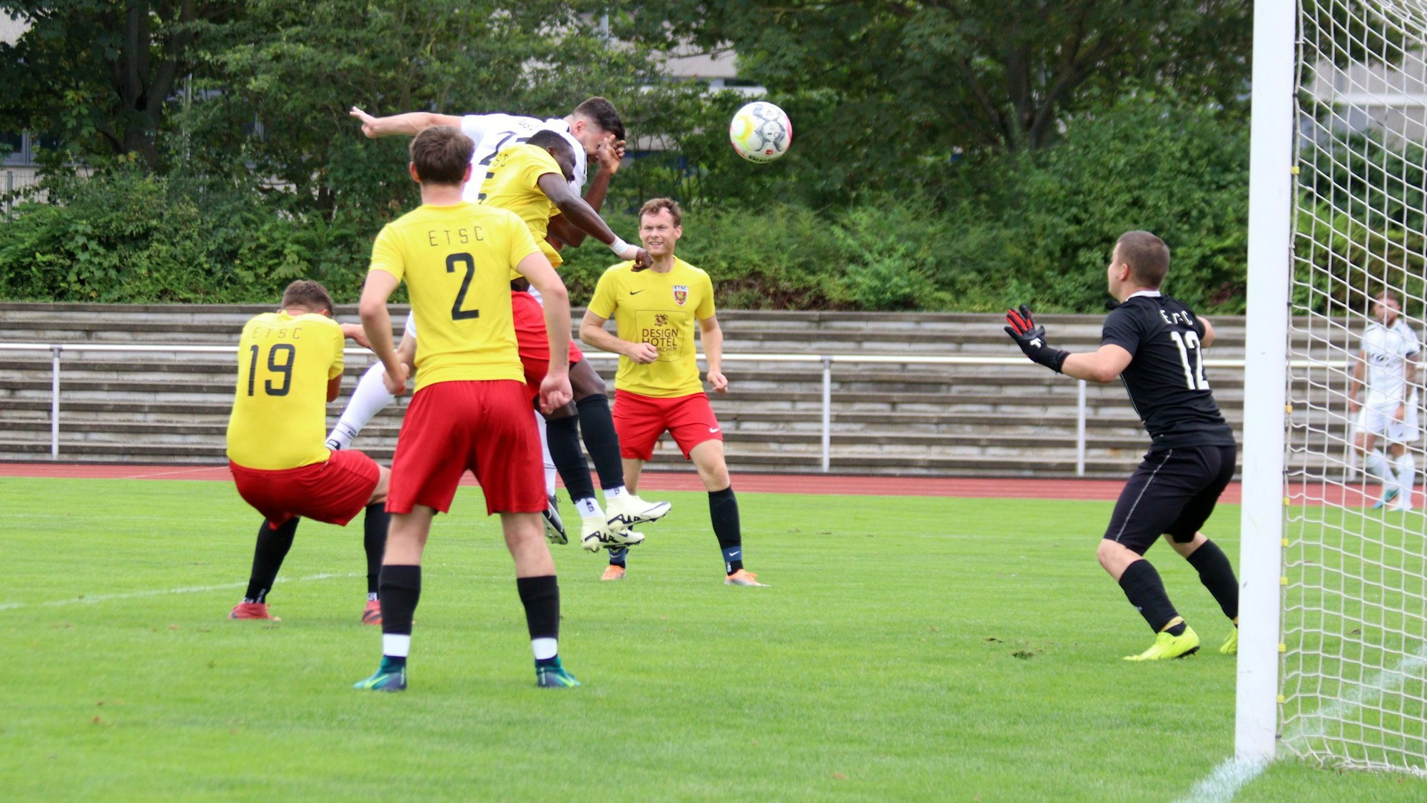 Ein Zülpicher Spieler springt nach einem Eckball hoch. Er ist umringt von Euskirchener Gegenspielern. Einer trifft ihn mit der Hand im Gesicht.